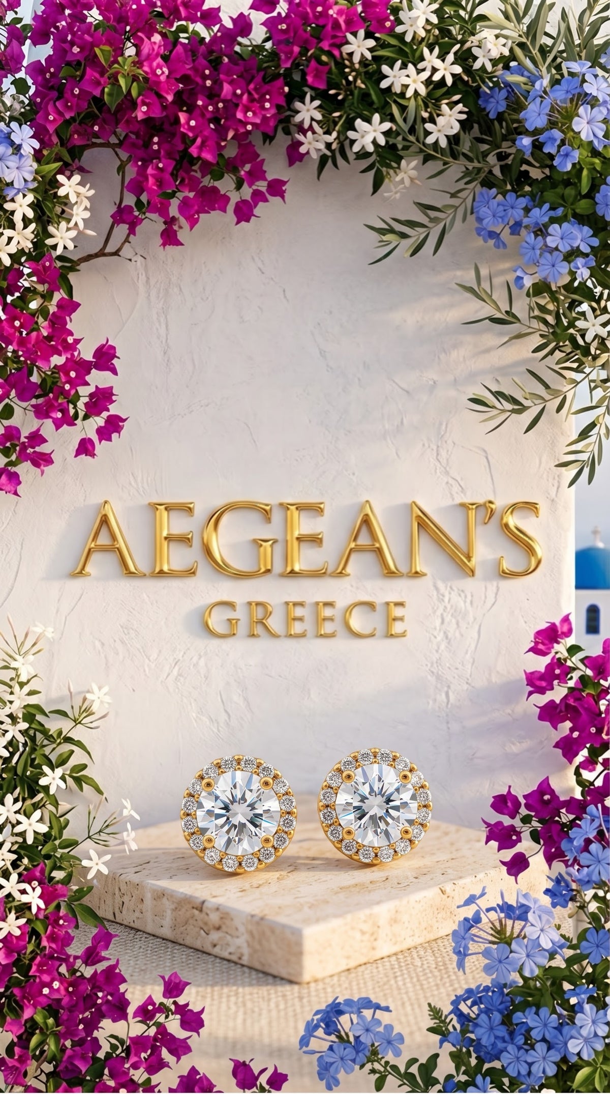 ELENA luxury gold-plated round halo earrings with 7 mm white French cubic zirconia from Aegean's Greece placed on a light stone block surrounded by pink bougainvillea, white flowers, blue flowers, and a Greek blue dome in the background